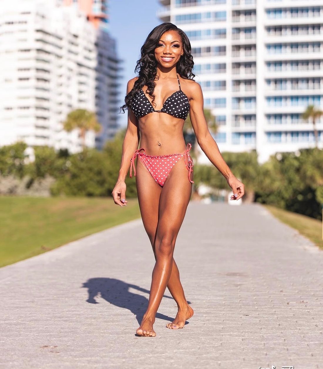 Woman walking along a waterfront path
